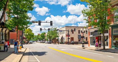 View of downtown Franklin, TN under a bright blue sky with historic buildings and street lights
