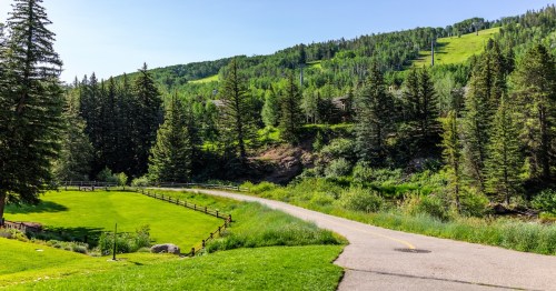 Vail, Colorado Lionshead Village park view of street bike walking pedestrian path in summer by mountain ski slopes