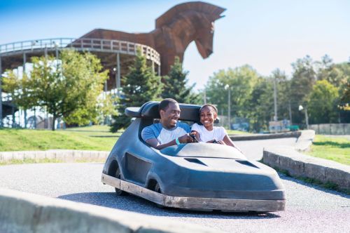 A father and son riding go-karts on the Trojan Horse track