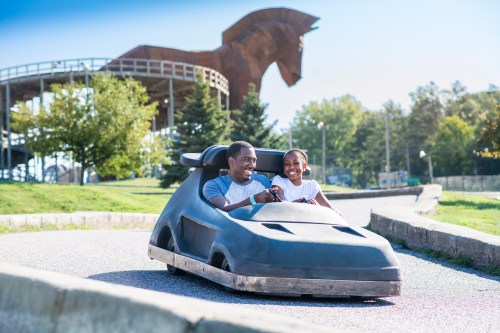Father and son riding a go-kart on the Trojan Horse track at Mt. Olympus
