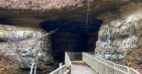 Boardwalk leading into the massive rocky opening of Donaldson Cave at Spring Mill State Park, Indiana.