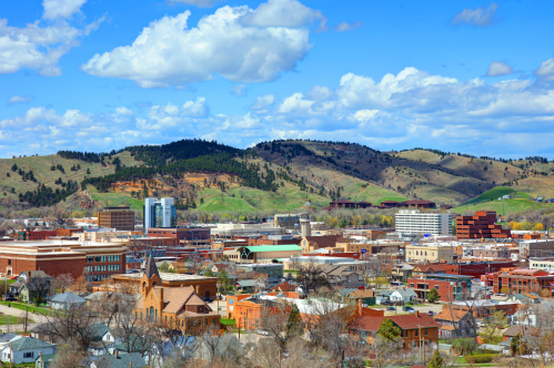 Downtown Rapid City, SD, is set against a panorama of rolling green hills