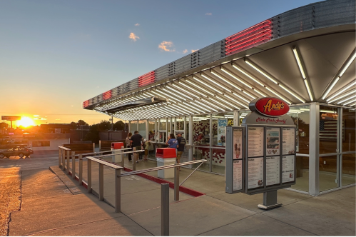 A brightly lit canopy and colorful menu welcome visitors to Andy's Frozen Custard
