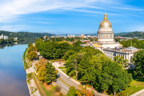 View of Charleston, West Virginia, including the river and capital building on a sunny day