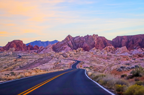 a paved scenic byway runs through the red rock landscape of Valley of Fire State Park in Nevada