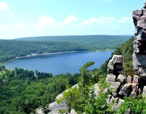 Tall rock formations with a lake in the background.