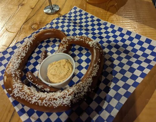 A large German pretzel with cheese dip.