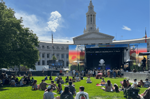 A grassy lawn with an outdoor music stage