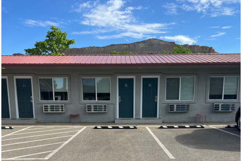 The exterior of the motel property with the mountains in the background
