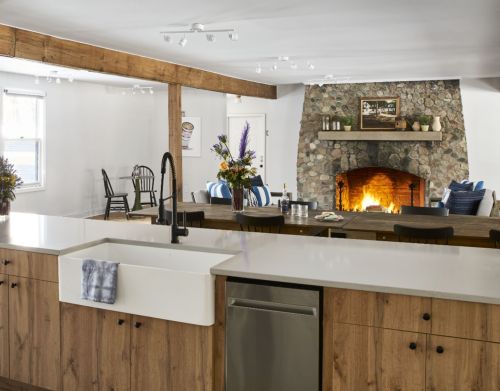 A communal kitchen with a fireplace in the background.