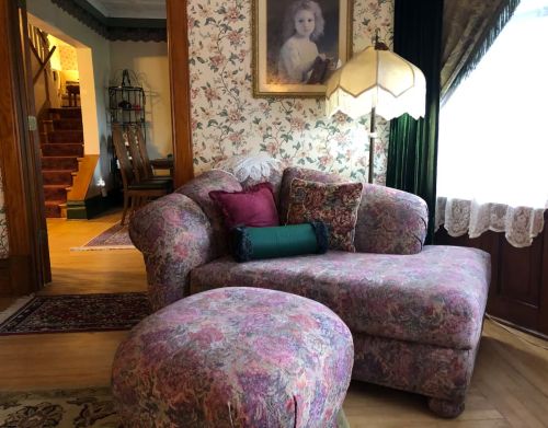 A purple sofa and ottoman.