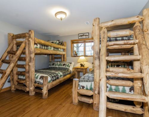 A set of two bunk beds that are made of wood.