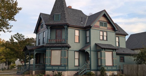 A dark green and black Victorian-style Airbnb in Kansas.