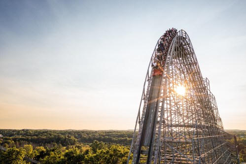 The sun peeking out from behind a roller coaster at Mt Olympus