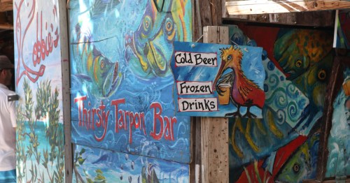 Inside of Robbie's in Florida, with colorful murals near the bar
