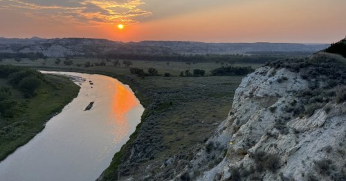 The sun sets over the rugged landscape of Rough Rider State Park in North Dakota.
