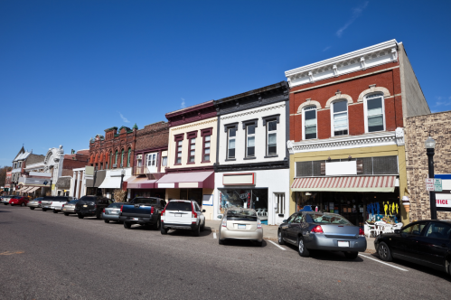 A row of colorful historic buildings line a small town square in Baraboo, WI