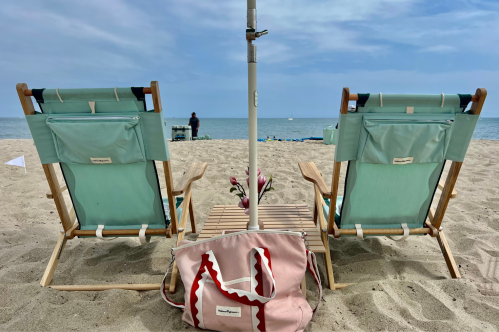 Two chairs on the beach.