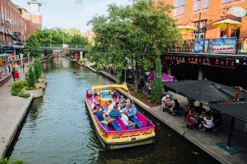 A boat glides along the river in OKC