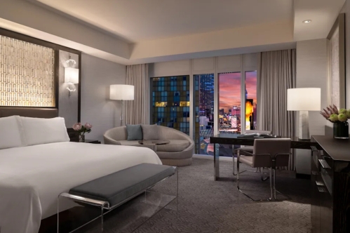 interior of a contemporary style hotel room at the waldorf astoria las vegas with views of the strip at night