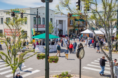 Festival in Fairhope, Alabama, with vendors, tents, and citizens walking around on a sunny day