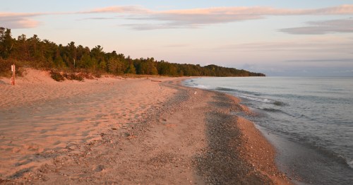 Rocky shoreline at Hoeft State Park near Rogers City, Michigan along the Lake Huron coast at sunset.