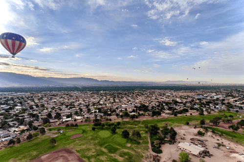 A hot air balloon hovers over the Earth