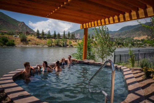 A group of friends sitting in the hot springs.