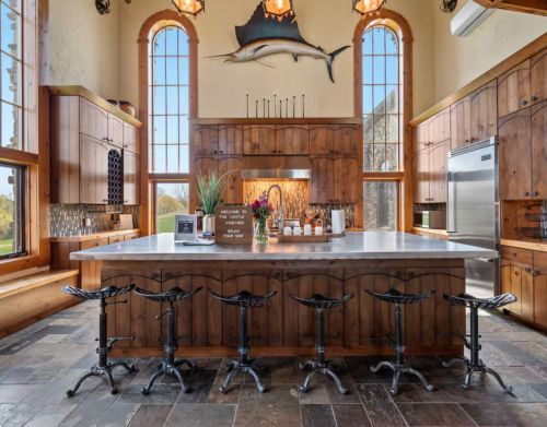 An ornate wooden kitchen with a large sailfish hanging above the oven.