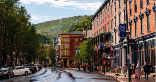 A street in Jim Thorpe, Pennsylvania, featuring historic Victorian architecture against the backdrop of the Pocono Mountains.