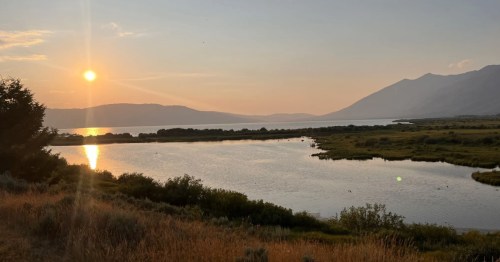 The sun sets over the water at Henrys Lake State Park in Idaho.
