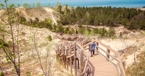 a boardwalk staircase leads down the dunes to the water at indiana dunes national park in indiana