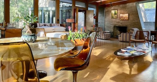 a classy and elegant mid century modern interior living room with a table and chair