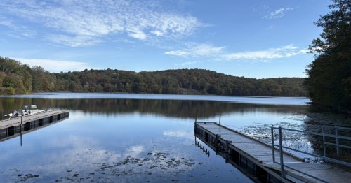 view of a small dock in a lake at Ringwood State Park in New Jersey