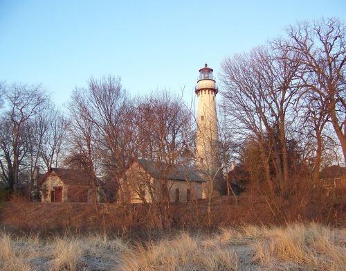 A lighthouse behind trees.