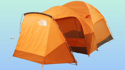 An orange tent set against a gradient blue background, featuring the North Face logo on the front.