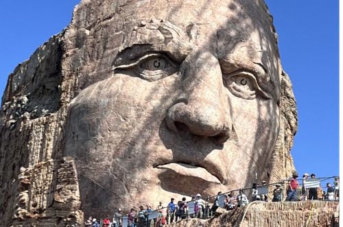 A close-up of the face of a mountainside sculpture of Chief Crazy Horse