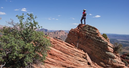 A woman stands on top of Lambs Knoll near Zion National Park in southern Utah.