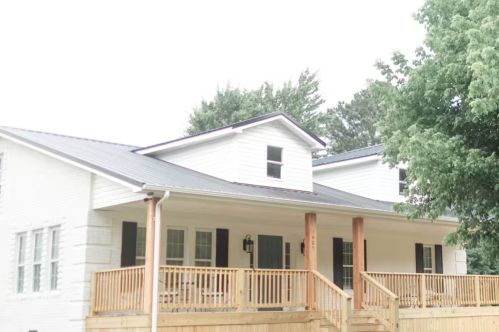 Exterior of an Airbnb near Mammoth Cave National Park with a large front porch
