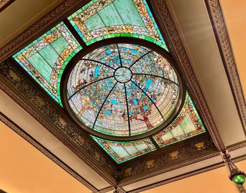 A colorful stained glass window on the ceiling of a home.