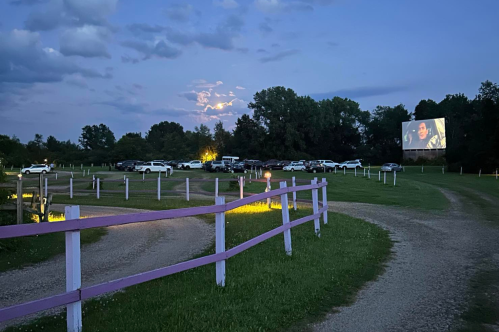 Big Sky Twin Drive-In at dusk with movie playing