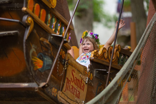 A child in a ride at the Bristol Renaissance Faire