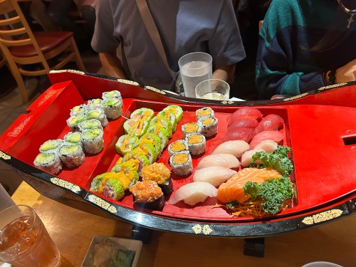 Sushi boat with rolls and sashimi at Miga in Denville