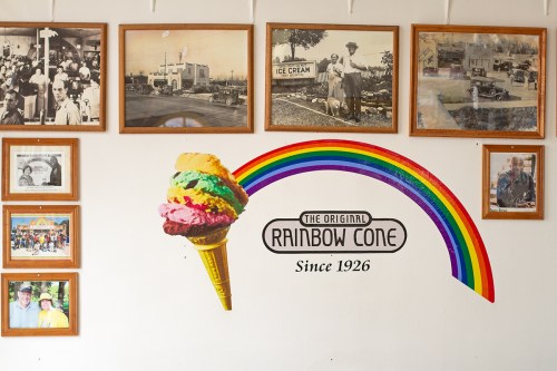 Wall at Rainbow Cone with the ice cream logo and framed photos