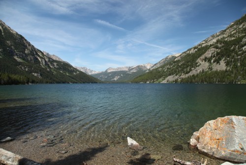 large blue-green lake with mountains surrounding by at mystic lake in montana