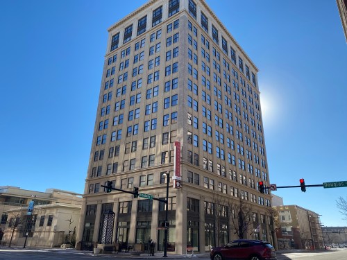 Exterior of a hotel building in front of a blue sky