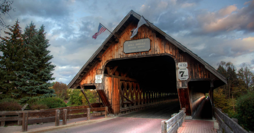 The entrance to a covered bridge on a cloudy day in Michigan.