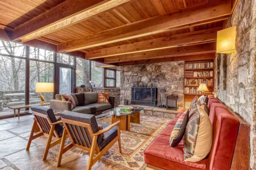 McCarty House living space with wooden ceiling, massive windows, and eclectic furniture