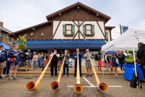 Men dressed in traditional clothes play in New Glarus