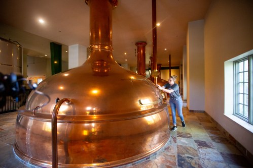 The distillery's equipment for making whiskey shines bright copper.